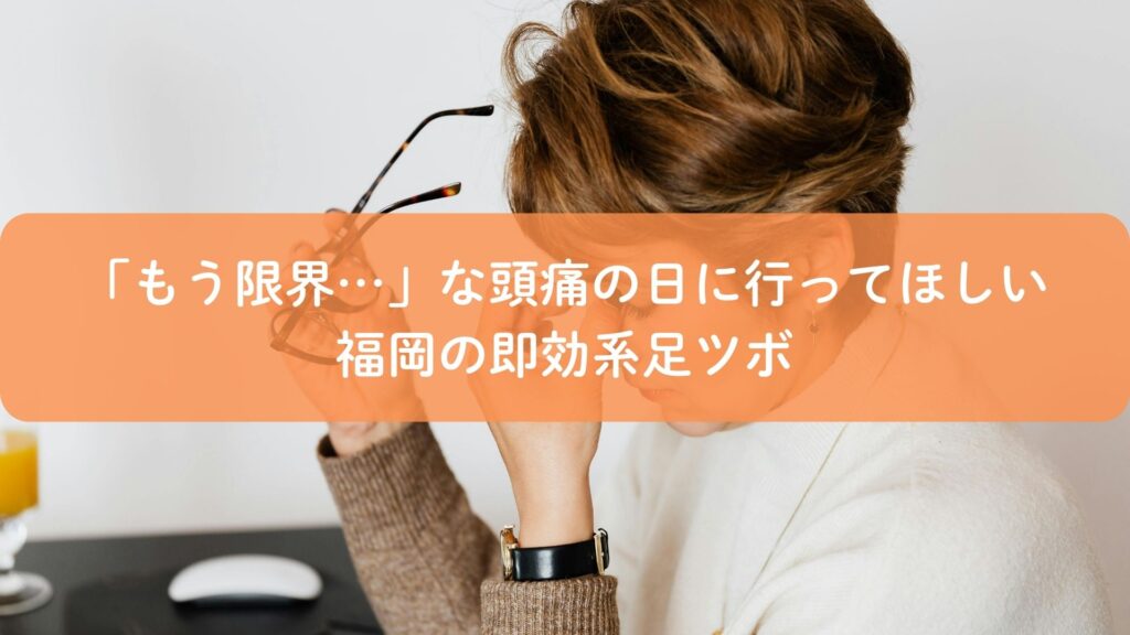 頭痛に悩み、こめかみを押さえる女性。福岡で即効性が期待できる足ツボ施術のイメージ